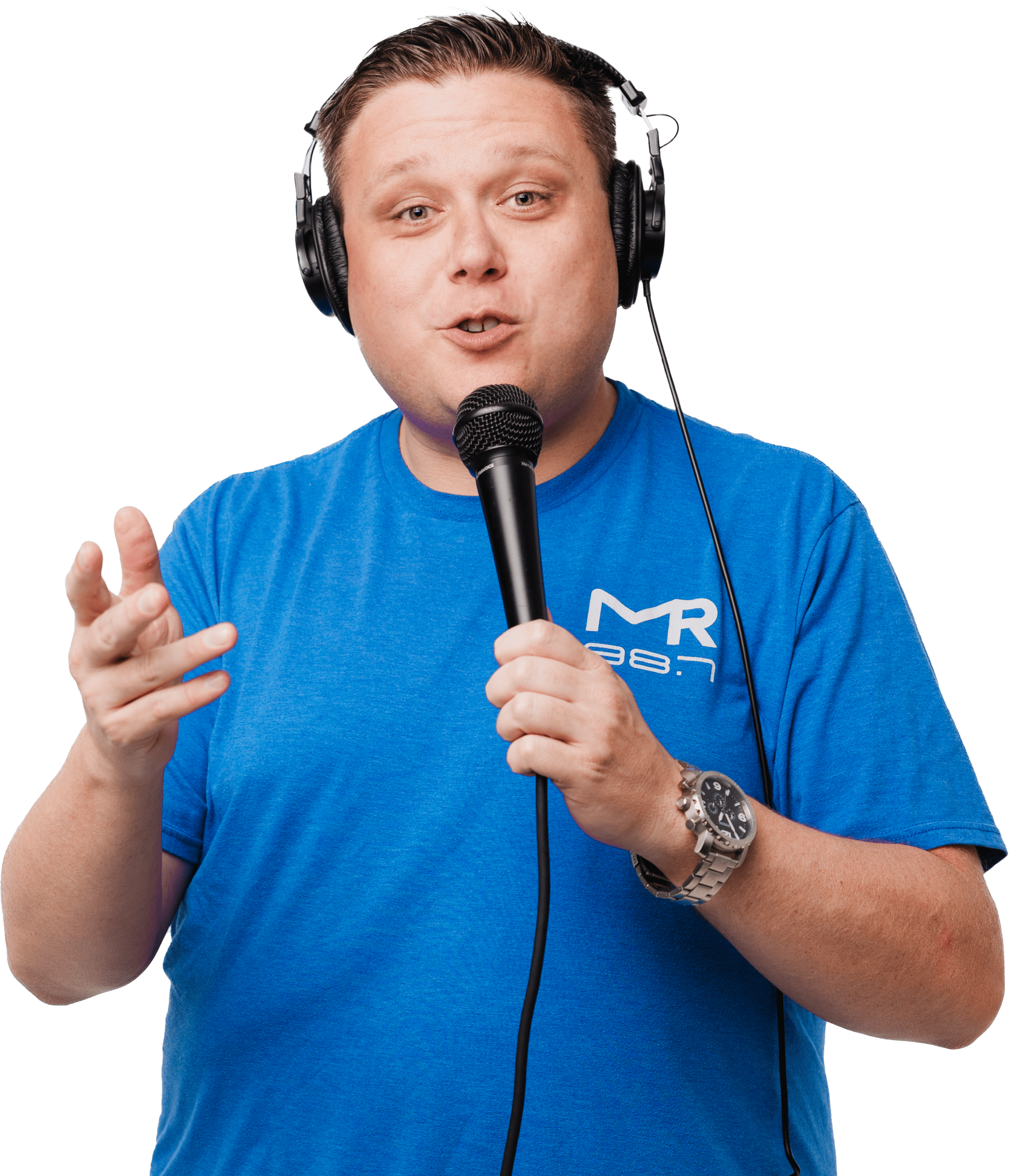 Randy Slack with studio monitors on holding a microphone in a royal blue shirt